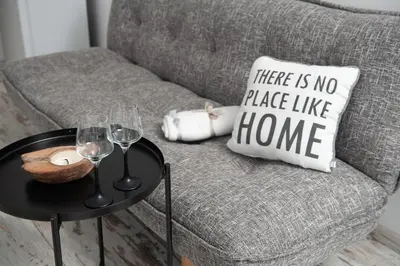 a gray couch with a table with wine glasses at Business sky Loft in Sofia