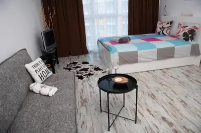 a living room with a couch and a bed at Business sky Loft in Sofia