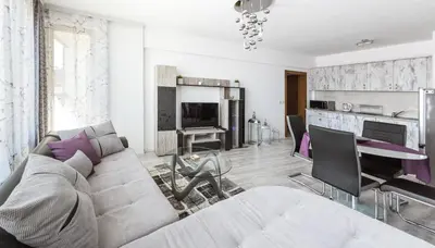 a living room with a couch and a table at NEXT TO GONDOLA. Cosy & Elegant 2 Bedroom apartment in Neon Complex in Bansko