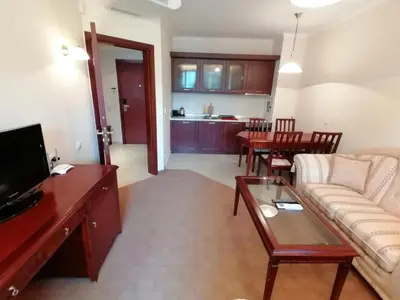 a living room with a couch and a table at Downtown Luxury private apartments in Bansko