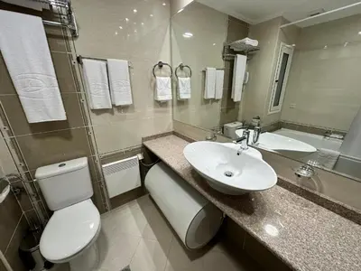 a bathroom with a white toilet and a sink at Downtown Luxury private apartments in Bansko
