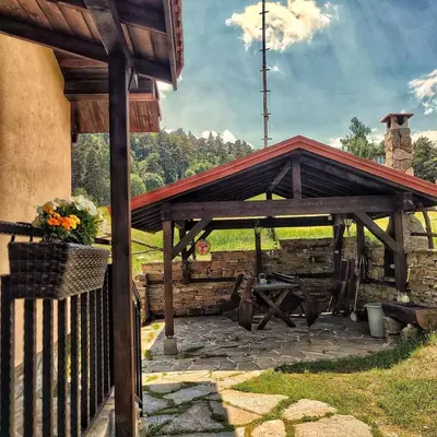 a wooden pavilion with a picnic table in a field at Вила Приказка in Tsar Kaloyan