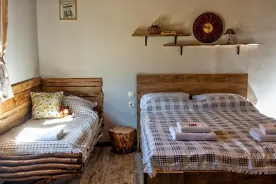 a bedroom with two twin beds and a table at Вила Приказка in Tsar Kaloyan