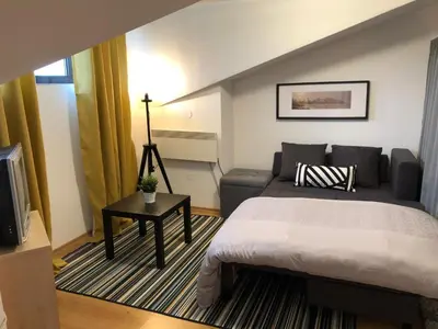 a hotel room with a bed and a couch at Stylish Studio Apart Aspen Golf Resort in Razlog