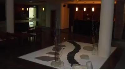a room with a table with rocks and a vase at Stylish Studio Apart Aspen Golf Resort in Razlog