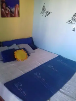 a bedroom with a bed with a yellow flower on it at MVK in Sofia