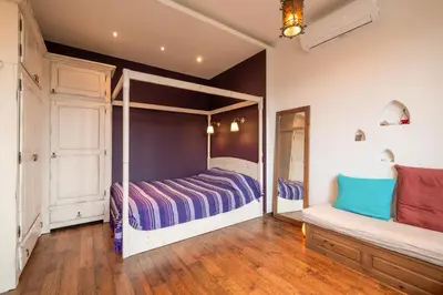 a bedroom with a canopy bed and a mirror at Kings Park Boutique Apartment in Sofia