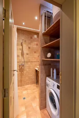 a bathroom with a washing machine and a shower at Kings Park Boutique Apartment in Sofia