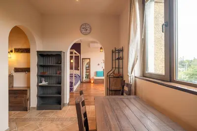 a living room with a table and a window at Kings Park Boutique Apartment in Sofia