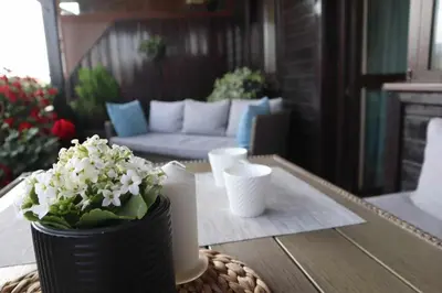 a patio with a table with white flowers on it at Studio- apartament Lake View Pravets Golf Resort in Pravets