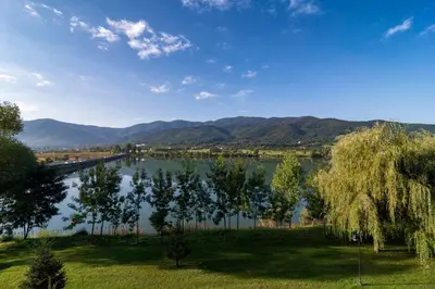 a view of a river with trees and a bridge at Studio- apartament Lake View Pravets Golf Resort in Pravets