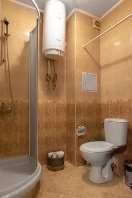a bathroom with a toilet and a shower and a sink at Studio Talisman II in Sofia