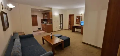 a living room with a couch and a table at Lucy's Apartments Emerald in Bansko