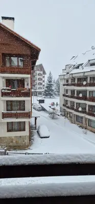 a snow covered city with buildings and condos at Lucy's Apartments Emerald in Bansko