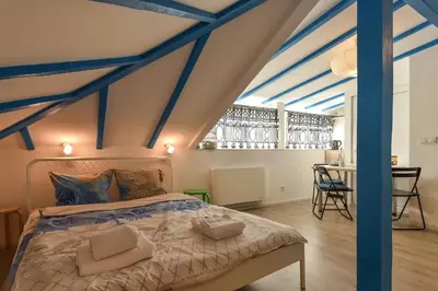 a bedroom with a bed with blue beams at The Ivy House - A Cozy Attic near the City Center by Flat Mаnager in Sofia