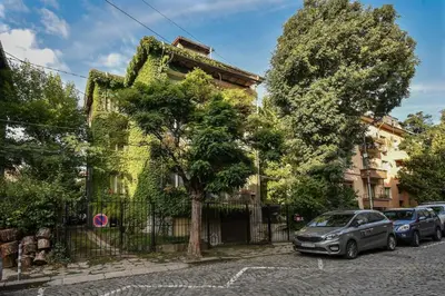 a house with cars parked in front of it at The Ivy House - A Cozy Attic near the City Center by Flat Mаnager in Sofia