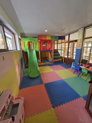 a play room with a slide and a playground at Elegance Spa Hotel in Ognyanovo