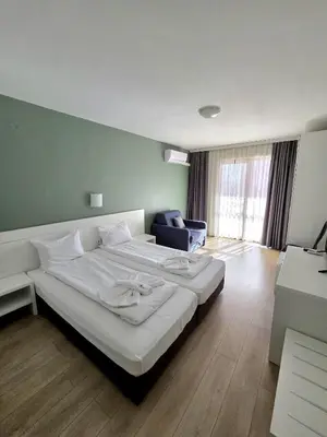 a bedroom with a large white bed in a room at Elegance Spa Hotel in Ognyanovo