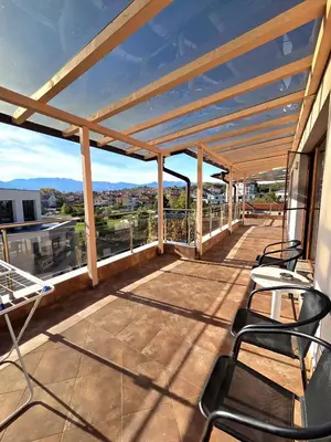 a balcony with chairs and a view of the city at Elegance Spa Hotel in Ognyanovo