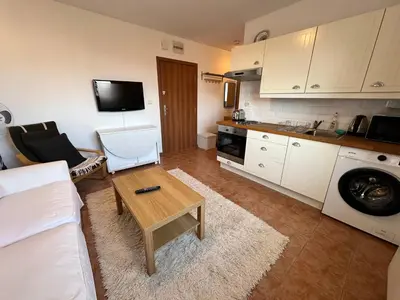 a living room with a couch and a table at Private apartment in Prespa in Bansko