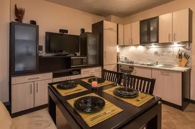 a kitchen with a table and a dining room at Charming, Fully-furnished, 2-bedroom apartment by Flat Mаnager in Bansko