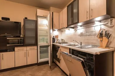 a kitchen with a sink and a stove top oven at Charming, Fully-furnished, 2-bedroom apartment by Flat Mаnager in Bansko
