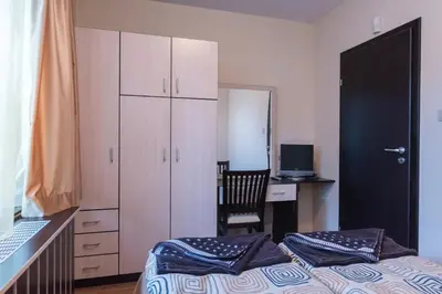 a bedroom with a bed and a desk with a computer at Charming, Fully-furnished, 2-bedroom apartment by Flat Mаnager in Bansko