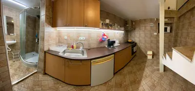 a kitchen with a sink and a shower and a tub at KCT Downtown Apartment in Sofia