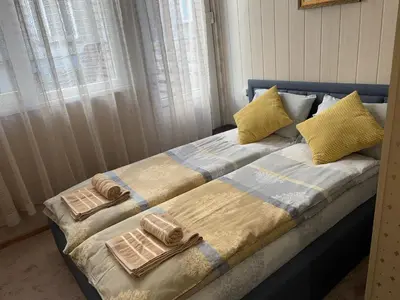 a bed with towels and pillows on top of it at KCT Downtown Apartment in Sofia