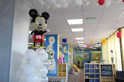 a room with a mickey mouse balloon hanging from the ceiling at Семеен Хотел Дани in Asenovgrad