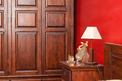 a room with red walls and a table with a lamp at Bansko Royal 721 Apartment in Bansko