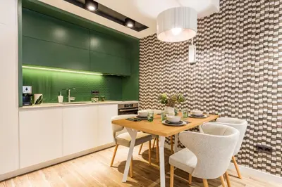 a kitchen with a wooden table and white chairs at SCA Sofia City Apartments in Sofia