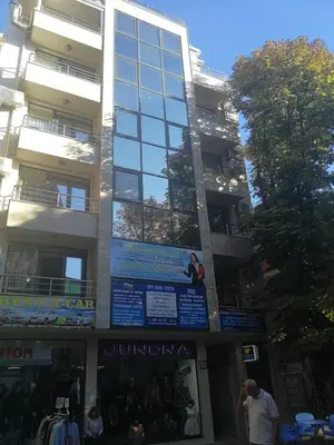 a tall building with people standing in front of it at Луксозен апартамент в идеалния център на град Сандански in Sandanski