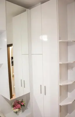 a white closet with a mirror and flowers in it at Luxury suite near NDK and Viotosha blvd in Sofia