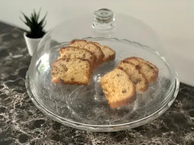 a glass plate with three pieces of bread on it at Spacious modern vintage flat in the heart of Sofia in Sofia