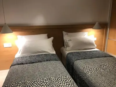 two beds sitting next to each other in a room at Riverside apart in Blagoevgrad