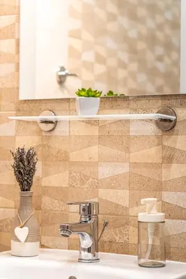 a bathroom with a sink with a mirror and a sink at Gladstone suites in Plovdiv
