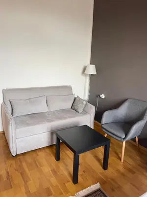 a living room with a couch and a chair and a table at Dara House in Plovdiv