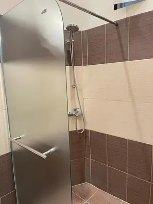 a shower with a glass door in a bathroom at Dara House in Plovdiv