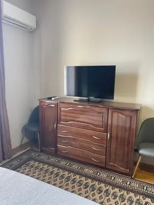 a flat screen tv on a wooden dresser in a room at Dara House in Plovdiv