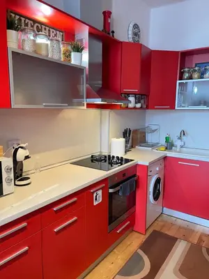 a kitchen with red cabinets and a stove top oven at Dara House in Plovdiv