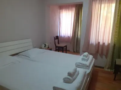 a bedroom with a bed with two towels on it at Семеен Хотел Хайдутите in Sandanski