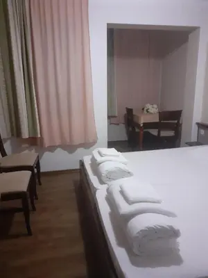 a group of towels on a bed in a room at Семеен Хотел Хайдутите in Sandanski
