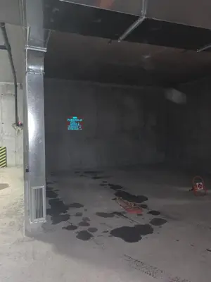 an empty parking garage with a sign on the wall at ComfortApartment IGLIKA 2 in Borovets