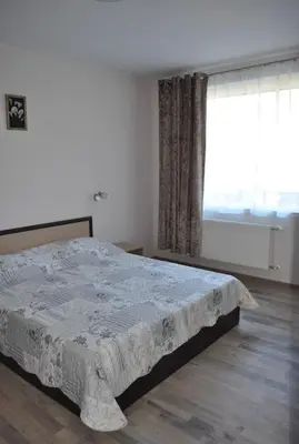 a bedroom with a large bed in front of a window at ComfortApartment IGLIKA 2 in Borovets