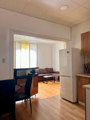 a kitchen and living room with a white refrigerator at Serdika station, bright and cozy apartment in Sofia