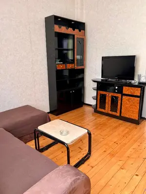 a living room with a couch and a flat screen tv at Serdika station, bright and cozy apartment in Sofia