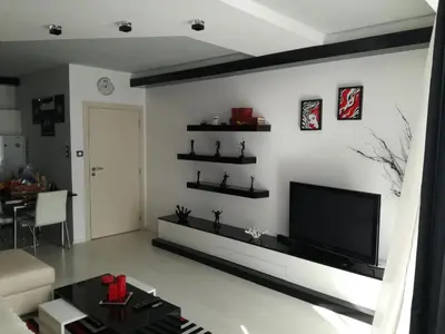 a living room with a flat screen tv on a wall at Apartment 33 in Hotel Iceberg in Borovets