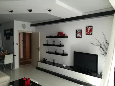 a living room with a flat screen tv on a wall at Apartment 33 in Hotel Iceberg in Borovets