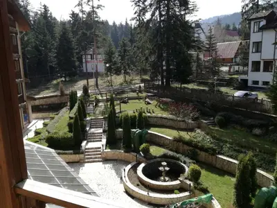 a view of a garden from a window at Apartment 33 in Hotel Iceberg in Borovets
